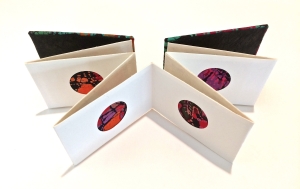 Accordion book with circle cut outs and batik fabric inserts